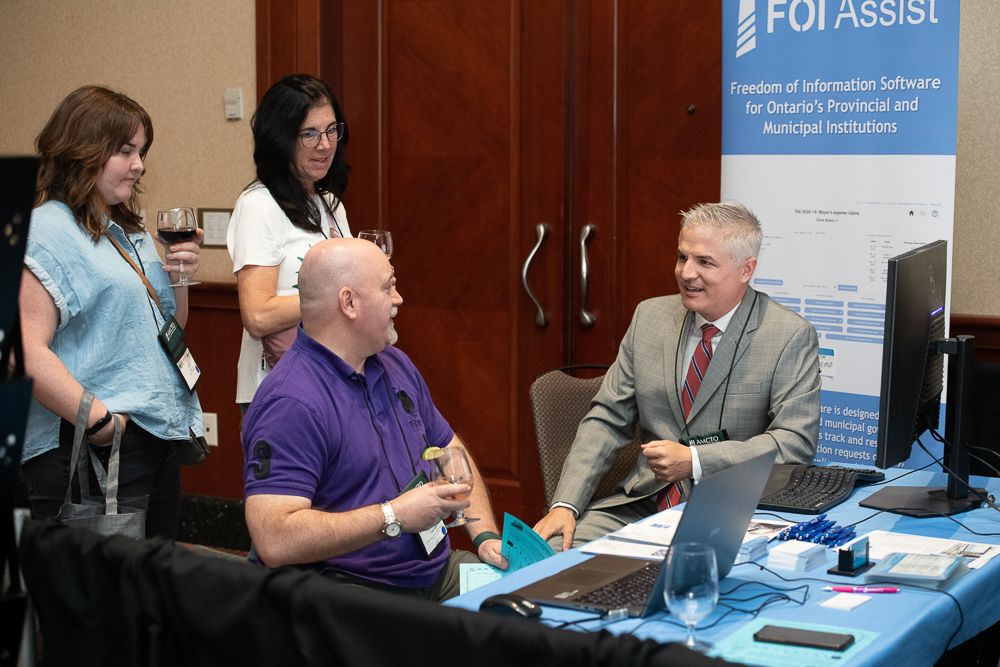 Justin Petrillo, founder of FOI Assist, with AMCTO Conference attendees