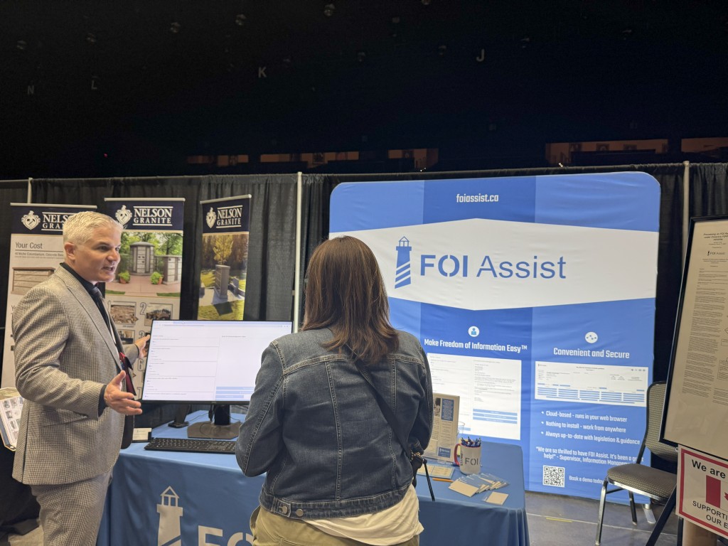 FOI Assist Founder and Principal Justin Petrillo explaining the FOI Assist software to a conference attendee.